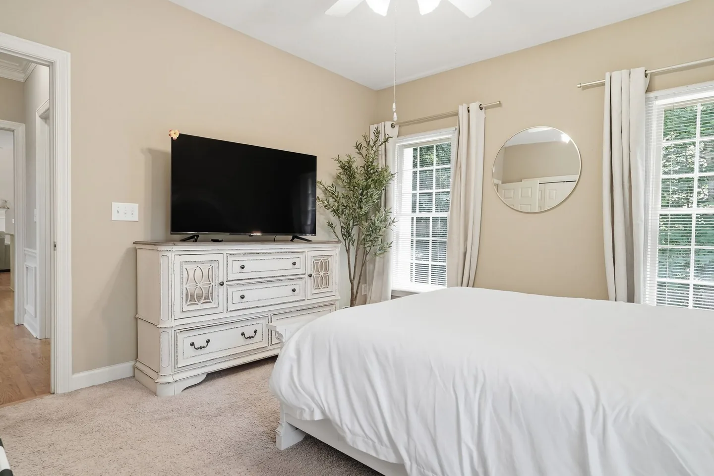 Bedroom with bed and seating area near the windows