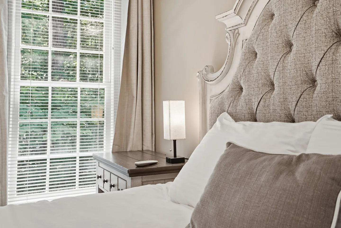 Bedroom with television, dresser, and mirror