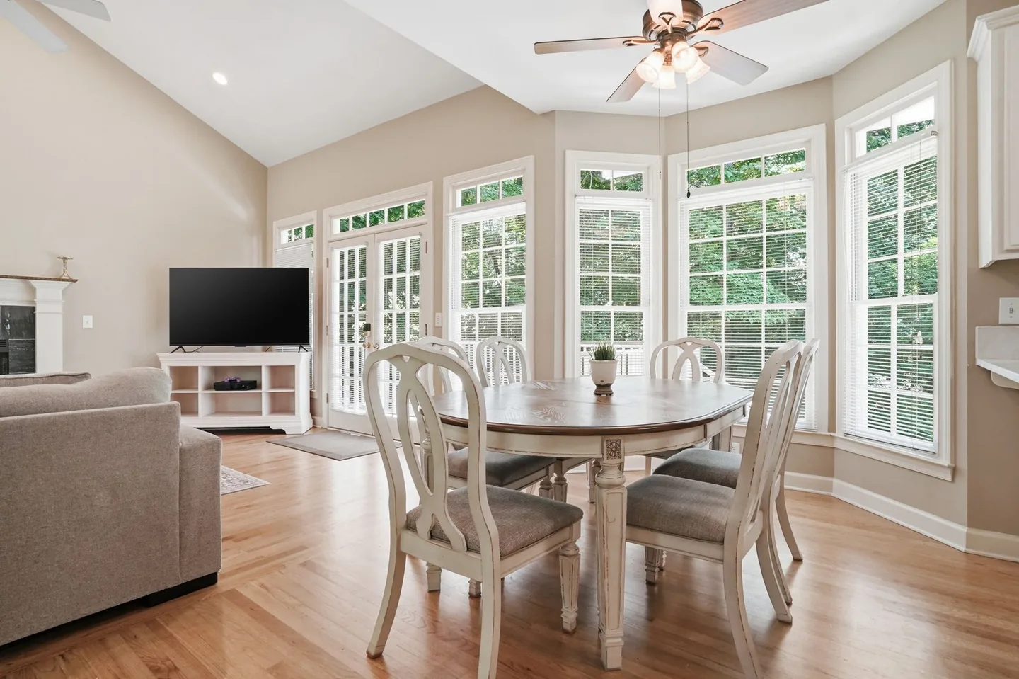 Open dining and living space with large windows