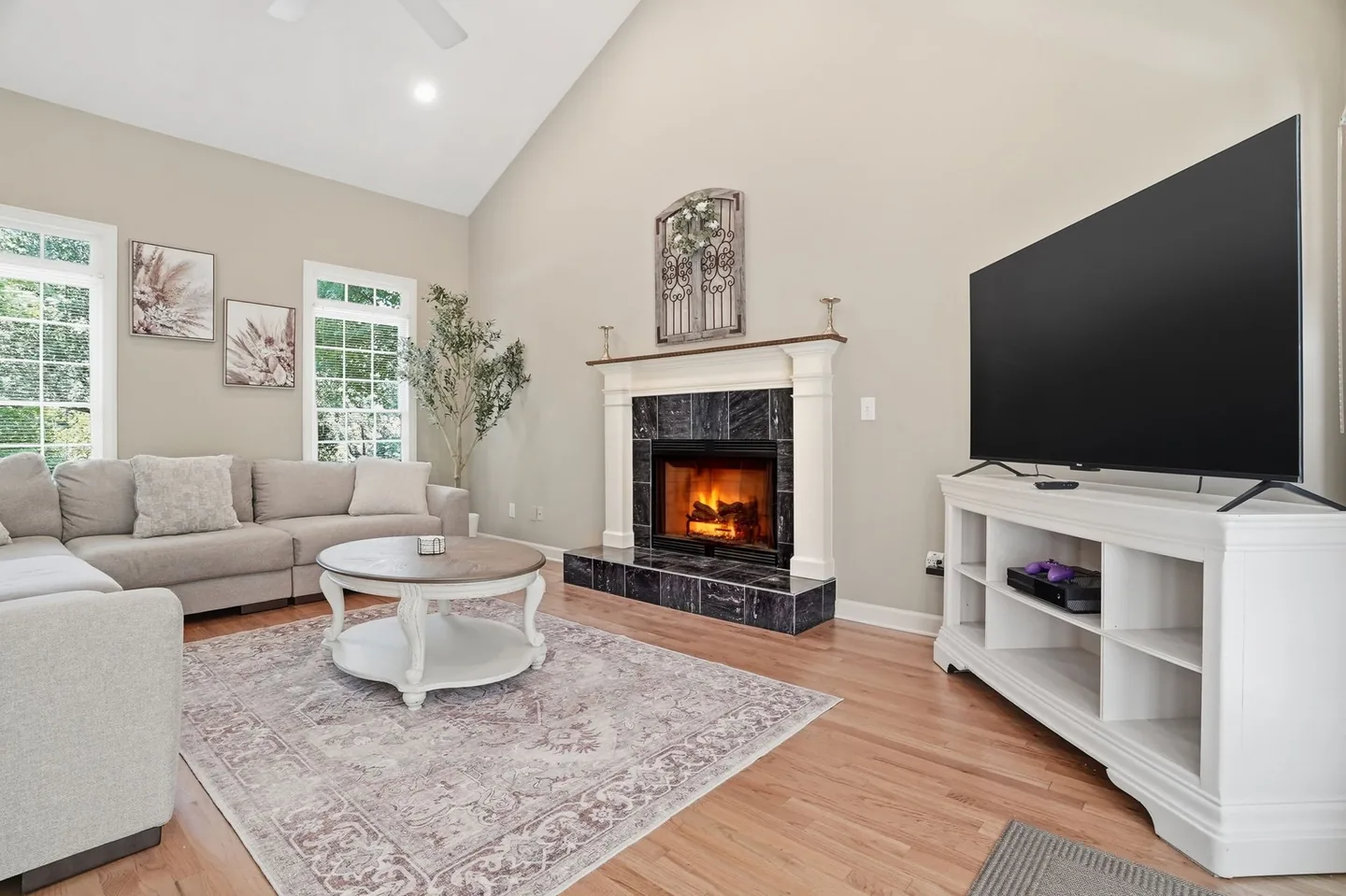 Living room with fireplace, television, and seating
